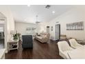 Spacious living room with ample seating, modern decor, and hardwood floors at 9504 Sw 97Th Ln # B, Ocala, FL 34481