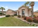 Charming single-Gathering home with a well-manicured lawn, paver driveway and two-car garage, complemented by palm trees at 9863 Sw 63Rd Loop, Ocala, FL 34481