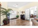 Elegant foyer with wood floors, plant, and decorative features adding warmth and style to the entrance at 10055 Sw 90Th Loop, Ocala, FL 34481