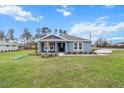 Charming single-story home with blue siding, manicured lawn, and fresh landscaping at 10512 Sw 49Th Avenue Rd, Ocala, FL 34476