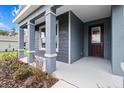 Inviting front porch with stately columns and a stylish front door at 10512 Sw 49Th Avenue Rd, Ocala, FL 34476
