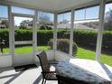 Bright sunroom features a table with floral tablecloth and backyard views at 11552 Sw 138Th Ln, Dunnellon, FL 34432