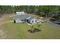 Stunning aerial view of a modern home with a spacious yard and separate garage at 13281 Sw 71St Ln, Ocala, FL 34481