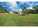 Inviting home with lush green lawn and palm trees, perfect for a serene lifestyle at 13281 Sw 71St Ln, Ocala, FL 34481