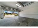Spacious two-car garage with ample room for vehicles and storage, featuring a large garage door at 17799 Se 125Th Cir, Summerfield, FL 34491