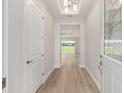 Bright entryway featuring wood-look flooring and decorative glass front door at 1929 Nw 85Th Loop, Ocala, FL 34475