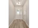Bright entryway featuring wood-look flooring and a glass-paneled front door at 1929 Nw 85Th Loop, Ocala, FL 34475