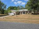 Single-Gathering home with a two-car garage and a well-maintained, though dry, front yard at 22 Hemlock Ter, Ocala, FL 34472