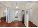 Open foyer featuring beautiful wood floors and plenty of natural light at 2399 Nw 53Rd Avenue Rd, Ocala, FL 34482