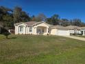 Charming one story home featuring a well maintained lawn, attached two-car garage, and a beautifully landscaped front yard at 2637 Ne 27Th St, Ocala, FL 34470