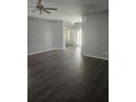 Spacious living room features lovely floors, neutral paint, and plenty of natural light from the sun shining through sheer window coverings at 2637 Ne 27Th St, Ocala, FL 34470