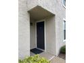 A front door with black paint stands out against the neutral tones of the building's exterior at 2923 Antique Oaks Cir # 39, Winter Park, FL 32792