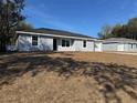 Attractive single-story home with an attached one-car garage and freshly laid straw landscaping at 2949 Se 144Th Pl, Summerfield, FL 34491