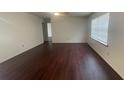 A well-lit living room area with a fan and wood floors at 4 Pine Pass Ter, Ocala, FL 34472
