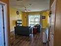Inviting living room with wood floors, ceiling fan, and sliding doors leading to the backyard at 4838 Sw 130Th St, Ocala, FL 34473