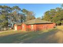 The house with its garage is on a grassy lawn with space for gardens and Gathering fun at 6611 Sw 80Th Ave, Ocala, FL 34481