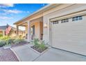 Exterior view of a home, showcasing the entrance with pillars and a two car garage at 8245 Sw 78Th Terrace Rd, Ocala, FL 34476