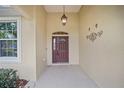 Inviting front entrance with decorative lighting and a traditional-style door at 8670 Sw 88Th Pl, Ocala, FL 34481