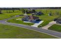 Wide aerial shot of a single Gathering house nestled on a spacious, green lot in a quiet neighborhood at 9594 Se 61St Ter, Belleview, FL 34420