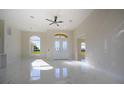 Open-concept living area boasts sleek marble floors, recessed lighting and a large arched window for natural light at 9594 Se 61St Ter, Belleview, FL 34420