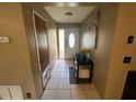 Entryway with tile flooring, a decorative front door, and a small table at 1008 Se 26Th St, Ocala, FL 34471