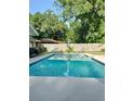 Refreshing in-ground pool is surrounded by a spacious patio, privacy fence, and backyard at 1008 Se 26Th St, Ocala, FL 34471