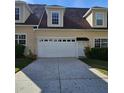 Exterior of home featuring a spacious two-car garage with a large driveway at 162 Riggings Way, Clermont, FL 34711