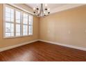 Dining room with wood floors, neutral walls, plantation shutters, and chandelier, ideal for hosting gatherings at 16276 Sw 14Th Ct, Ocala, FL 34473