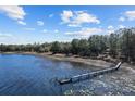 Scenic view of the lake featuring a private wooden dock, perfect for enjoying waterfront activities at 17153 Se 79Th Street Rd, Ocklawaha, FL 32179