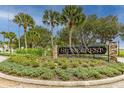 Stonecrest community entrance with lush landscaping and an elegant wrought iron sign at 17818 Se 120Th Ct, Summerfield, FL 34491