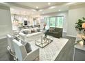 Bright and airy living room featuring an open floor plan, modern furniture, and sliding glass doors at 1955 Nw 79Th Loop, Ocala, FL 34475