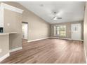 Open-concept living room featuring wood-look flooring, a ceiling fan, and lots of natural light at 20396 Sw 79Th Lane, Dunnellon, FL 34431