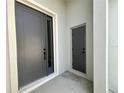 Modern gray front doors and entry provide security and visual appeal at 2728 Sw 154Th Place Rd, Ocala, FL 34473