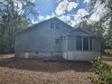 Back exterior of the house showing the foundation and some yard at 3081 Ne 49Th St, Ocala, FL 34479