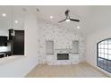 Living room showcasing a white-painted brick fireplace, built-in shelves and an arched window at 4534 Se 13Th St, Ocala, FL 34471