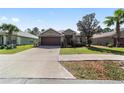 Inviting single-Gathering home with a neatly manicured lawn, mature landscaping, and a driveway at 5464 Sw 41St St, Ocala, FL 34474