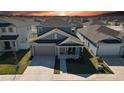 Aerial view of a blue single-Gathering home with a two-car garage and manicured lawn at 6320 Sw 74Th Terrace Rd, Ocala, FL 34474