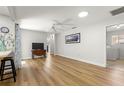 Bright and airy living room with wood floors, skylight, and views into the laundry at 8126 Sw 105Th Pl, Ocala, FL 34481