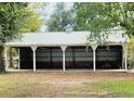 Spacious open barn featuring a metal roof and multiple bays, perfect for storage or equestrian activities at 8585 Nw 162Nd Ct, Morriston, FL 32668