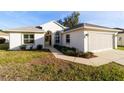 Inviting single-story home with well-maintained lawn, featuring a two-car garage and classic architectural details at 11569 Sw 71St Cir, Ocala, FL 34476