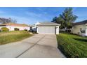 Well-kept single-story home highlighting a lush lawn and a practical two-car garage, blending comfort with functionality at 11569 Sw 71St Cir, Ocala, FL 34476