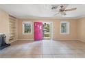 Bright living room with tile floors and a view of the landscaped front yard at 1225 Se 16Th St, Ocala, FL 34471