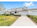 Charming townhome with a well-maintained lawn and a driveway leading to an attached garage at 1947 Se 37Th Court Cir, Ocala, FL 34471