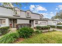 Townhouse exterior boasts mature landscaping, well-kept lawns, painted brick, and inviting curb appeal at 1947 Se 37Th Court Cir, Ocala, FL 34471