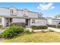 Welcoming front entrance with vibrant green bushes, a charming door wreath, and manicured garden at 1947 Se 37Th Court Cir, Ocala, FL 34471