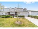 Beautiful townhome boasts a lush green lawn and a neatly paved driveway, showing curb appeal at 1947 Se 37Th Court Cir, Ocala, FL 34471