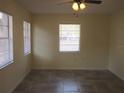 Bedroom with tiled floors, neutral paint and natural light from two windows at 3900 Sw 147Th Lane Rd, Ocala, FL 34473