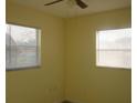 Bedroom featuring a ceiling fan and two windows at 3900 Sw 147Th Lane Rd, Ocala, FL 34473