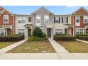 Townhomes featuring colorful exterior, well-maintained landscaping, and cozy front entryways at 4491 Sw 49Th Ave, Ocala, FL 34474