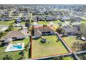 Aerial view of fenced backyard featuring a pool, trampoline, and ample green space at 4731 Se 32Nd St, Ocala, FL 34480